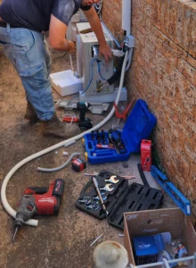 Technician installing air conditioner